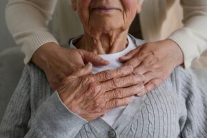 unrecognizable female expressing care towards an elderly lady