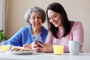 women are having fun using wi-fi and a smartphone